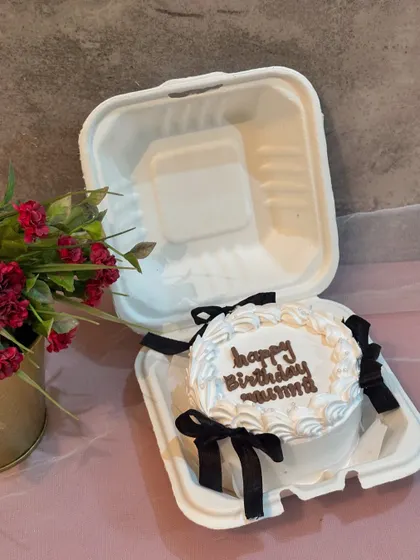 An elegant birthday bento cake for "Mummy" with delicate piping and black ribbons.