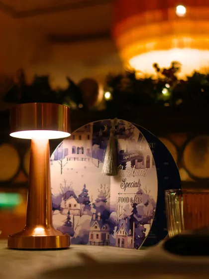 A close-up of our special Christmas menu, set on a beautifully decorated table. The warm lighting and festive details create a magical dining atmosphere.
