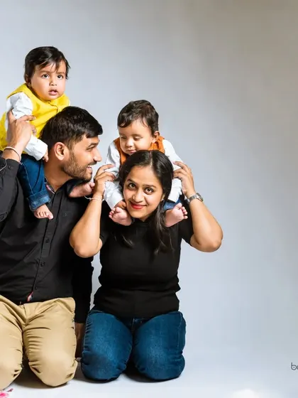 A playful family photo with twin boys enjoying a shoulder ride. I always make sure to include fun, interactive poses that capture the energy of your family.