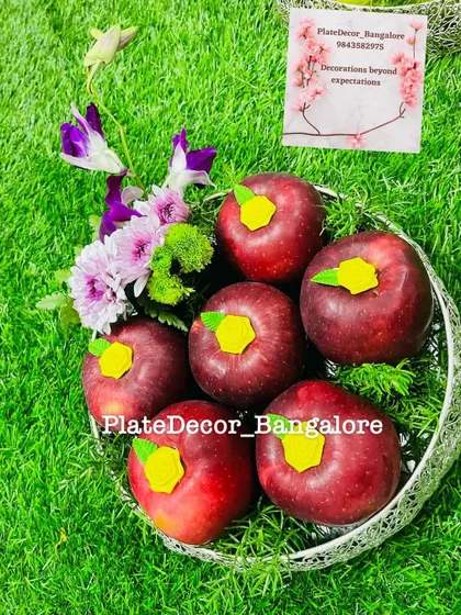 A simple and sweet design for red apples, each topped with a small yellow flower cutout. This is an affordable and neat decoration option.