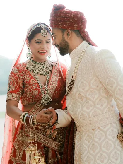 An intimate close-up of the couple holding hands, their faces filled with love and happiness. The soft, bright light adds to the romantic feel.