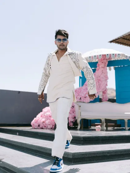 The groom, Rahul, looking like a star. His confident walk and stylish outfit make for a powerful solo portrait that is full of swagger and personality.
