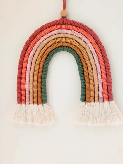 A simple shot of the earthy rainbow hanging on a white wall, showing how it can be a beautiful statement piece.