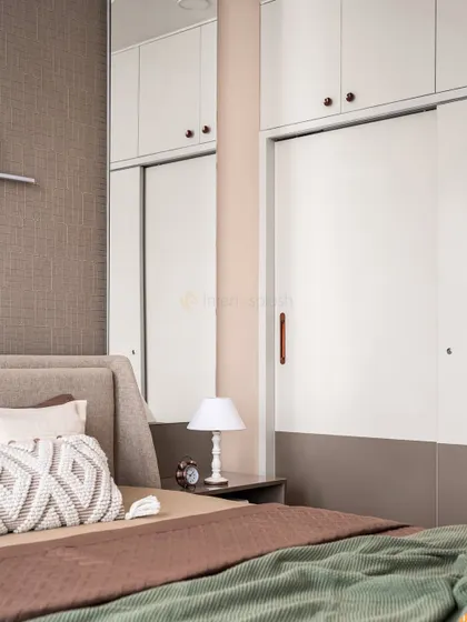A close-up of the sliding wardrobe and bedside table. The two-tone wardrobe doors add a subtle design detail to the room.