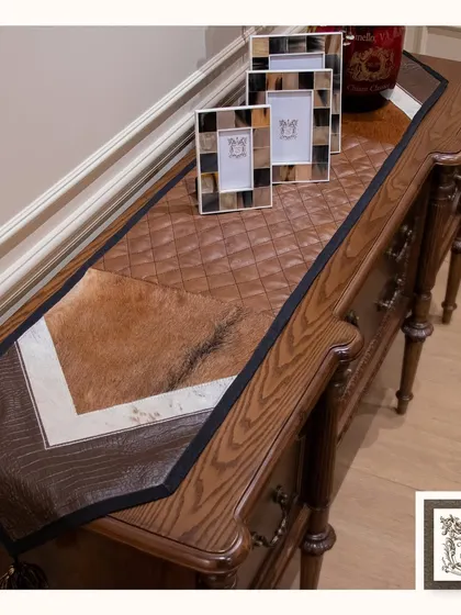 I love to play with textures, as seen in this handcrafted runner made from leather and hair-on hide. It transforms this classic wooden console into a statement of refined, rustic luxury.