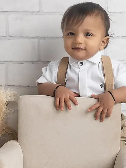 Standing tall and proud! This little one is exploring his first birthday setup, showing off his new standing skills.