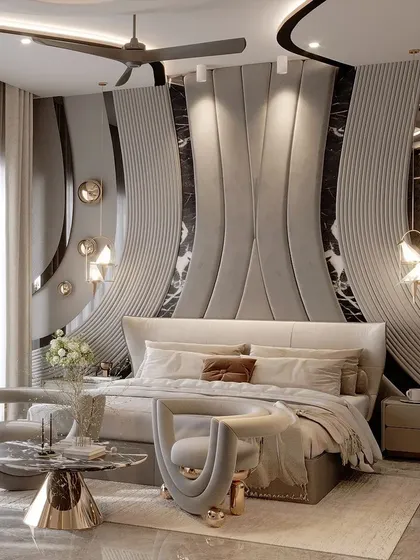 A different angle of the grey bedroom with curved walls, showing how the design flows around the room. The combination of soft fabrics, marble, and metallic accents creates a truly sensual and high-end aesthetic.