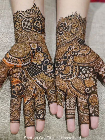 A beautiful example of a full-hand design with a mix of bold florals and intricate geometric patterns.