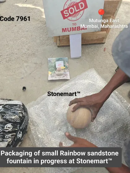 The packing of a small rainbow sandstone fountain in progress.
