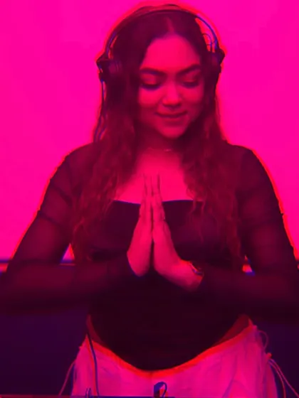 A moment of gratitude and peace behind the decks, captured with a cool pink filter.