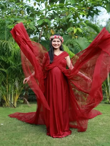 Another beautiful shot of the wine-colored A-line gown with its convertible straps used as flowing trails. The movement of the fabric adds a magical touch to this outdoor portrait.