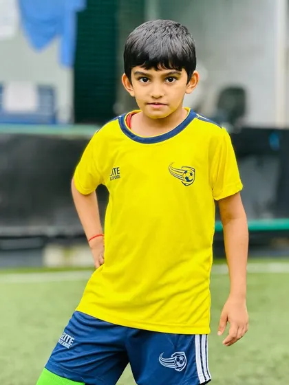 A young player poses with confidence. We love seeing our students grow in skill and self-esteem.