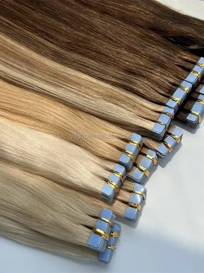 I offer a wide range of colors to ensure a perfect match. This image displays several shades of tape-in extensions, from dark brown to blonde, ready for custom blending.