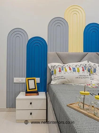 A close-up of the custom arched wall panels behind the bed. This is a simple yet effective way to add color and dimension to a kid's room wall.