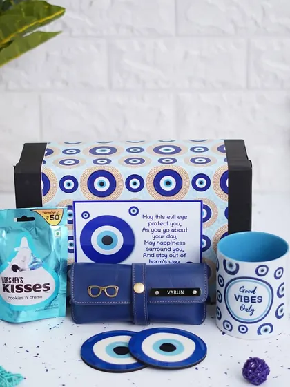 Protect your loved one with this Evil Eye themed hamper. It includes a "Good Vibes Only" mug, a personalized eyewear case, two evil eye coasters, and Hershey's chocolate.