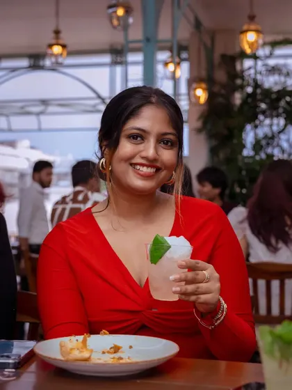 A guest smiles, a refreshing drink in hand, with a plate of our Puffizza 2.0 in front of her. It’s a moment of pure enjoyment, savoring the nostalgic flavors of my crafthouse.