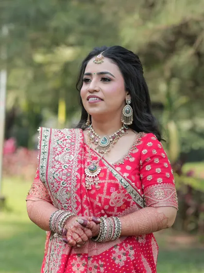 A candid shot of the bride during her outdoor engagement shoot. The makeup looks fresh and beautiful in the natural light.