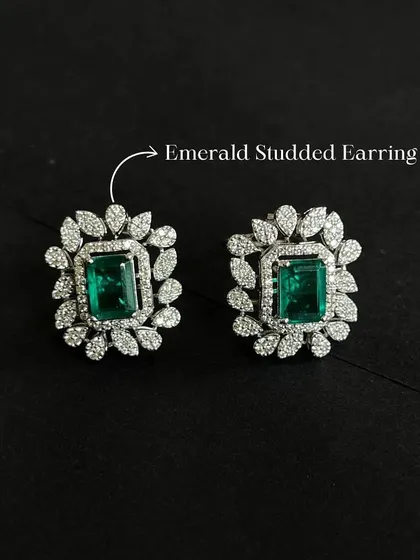 Get ready for the festive season with these emerald and diamond studded earrings. The rich green of the emerald provides a beautiful contrast to the sparkle of the surrounding diamonds.