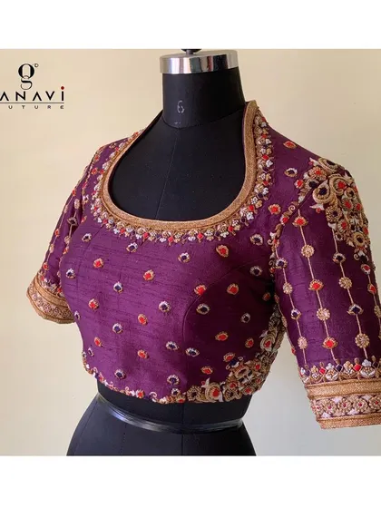 A regal purple blouse made from bandhani fabric and embellished with delicate embroidery. The combination of the traditional tie-dye pattern with the handwork creates a unique and culturally rich piece.