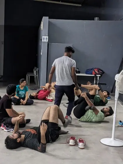 Players engage in post-session stretching led by a coach. We teach the importance of proper warm-ups and cool-downs to prevent injury and aid recovery.