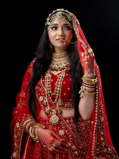 A detailed close-up of the Padmavathi look, highlighting the intricate headpiece, nose ring, and embroidered red lehenga, available for rent for your royal-themed shoot.