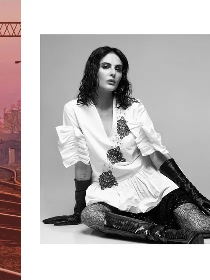Styling for actress Mandana Karimi in a campaign for designer Rocky Star. This look features a structured white top with black embellishments and leather gloves, creating a sophisticated and edgy fashion statement.