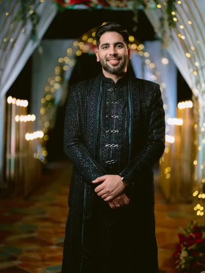A confident and happy portrait of the groom at his Sangeet.