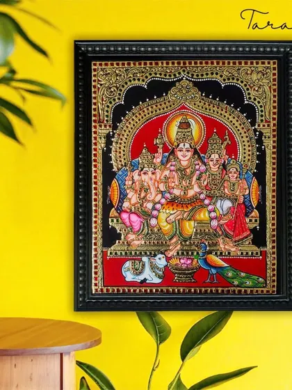 Displayed against a bright wall, our Shiva Family Tanjore painting becomes a vibrant spiritual centerpiece. The traditional art form brings a sense of depth and heritage to the room.