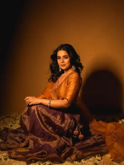 A full-length view of the look for Rashmi Agdekar. The makeup is designed to look beautiful from a distance and in person, not just in close-ups.