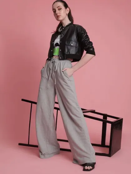 This look is all about layering and texture. I styled a cropped leather jacket over a graphic top and wide-leg grey trousers, creating a powerful silhouette that's both comfortable and chic.