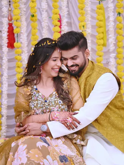 Another joyful portrait from the Haldi ceremony, capturing the couple's happy smiles and the festive atmosphere.