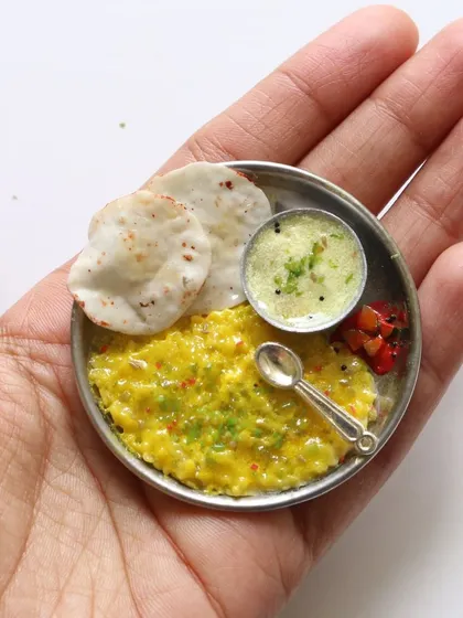 A cute miniature of khichdi and kadhi, a comforting and simple meal recreated in clay.