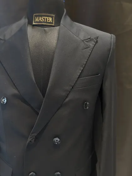 A classic black double-breasted suit is a must-have in any gentleman's wardrobe. I focus on sharp tailoring and peak lapels to create a powerful and timeless silhouette.