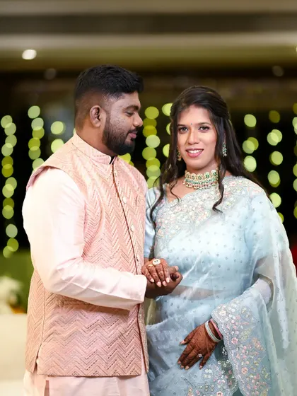 A happy, interactive portrait of the couple. The groom looks at his bride as she smiles at the camera, capturing a moment of shared joy.