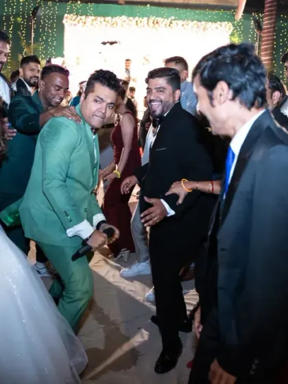 The emcee brings everyone together on the dance floor. Capturing these interactive moments shows the fun atmosphere of the wedding reception.