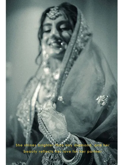 An artistic, blurry black and white shot of Vanaja, her smile shining through, capturing a moment of pure, uninhibited joy.