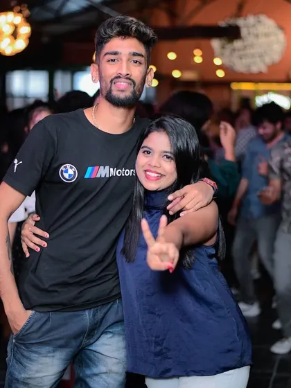 Posing with a friend on the dance floor. I love being part of the party and connecting with the people who come to my shows.
