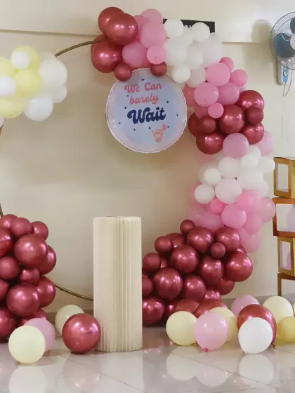A full view of the baby shower ring decoration. The setup includes "BABY" blocks and a mix of pastel and chrome balloons for a modern and chic look.