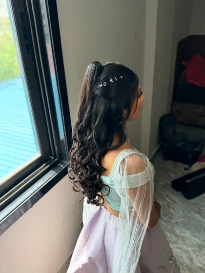 The side profile shows off the volume and bounce of the curly ponytail, a perfect hairstyle for dancing the night away.