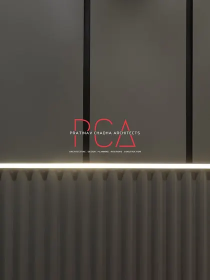 A close-up of the fluted wall paneling and integrated linear lighting in a bedroom at The Cursive Abode, showcasing the precision and texture of the design.