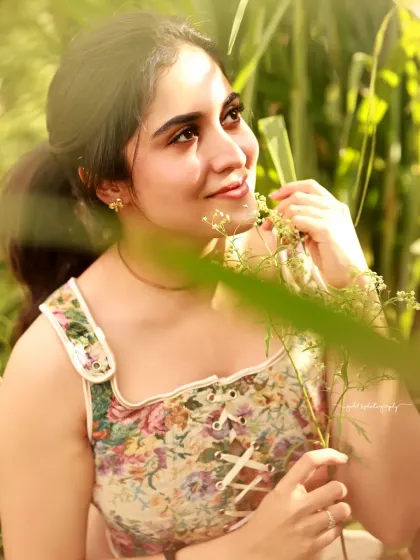 A close-up portrait of an actress surrounded by nature. The soft lighting and shallow depth of field make the subject pop while retaining the beauty of the natural environment.