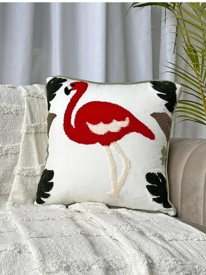 The flamingo cushion cover shown on a sofa, demonstrating how this single piece can become a focal point in your living room decor.