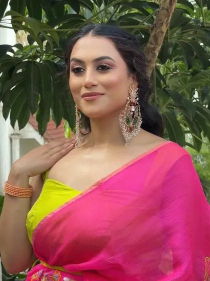 A bold and modern look for a sister's Haldi ceremony, featuring a vibrant pink and lime green saree.