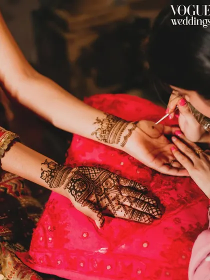 The intricate art of henna application, a detail shot featured in Vogue Weddings, showcasing the cultural richness of the celebration.