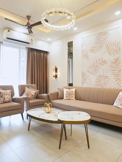 Here, a beige and brown color scheme creates a warm and inviting atmosphere. The statement chandelier and custom printed wall add a touch of grandeur and personality.