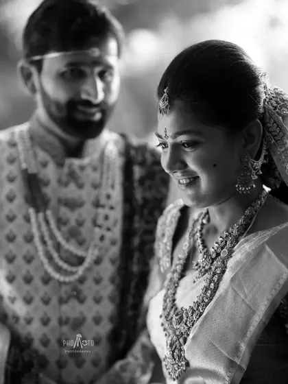 A timeless black and white portrait capturing a soft, gentle moment between the bride and groom.