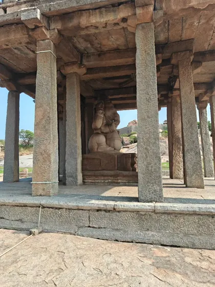 Another view of the giant Ganesha statue, housed within a stone mandapa.