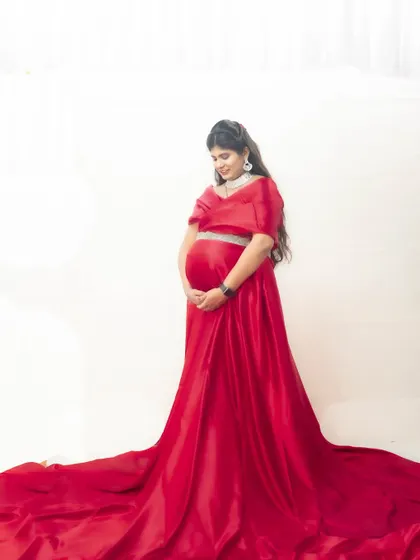 A side view of our red two-piece maternity gown, designed for both style and comfort.