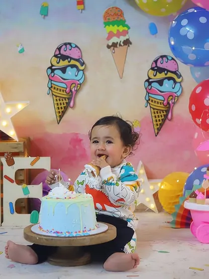 We all scream for ice cream! This little guy is about to enjoy his first birthday cake in this super sweet ice cream parlor setup.