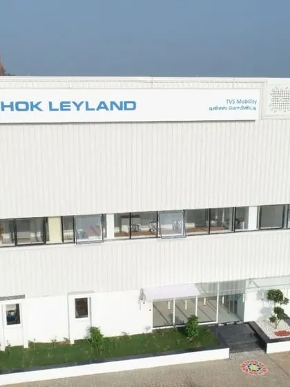 A frontal view of the main administrative block, showcasing the clear branding and professional entrance we designed for the facility. The architecture communicates the strength and reliability of the Ashok Leyland brand.